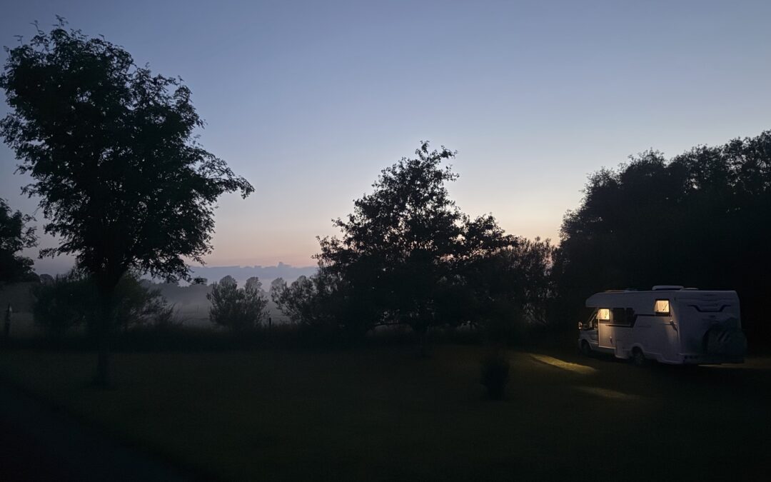 Motorhome in the morning mist overlooking a vineyard – a typical Pintrip stopover.